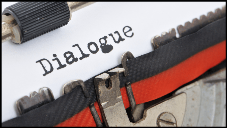 Close up of a typewriter paper with the word Dialogue typed out