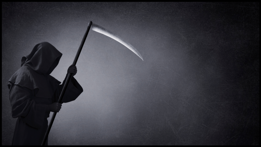Photo of a hooded figure holding a scythe. Grim Reaper