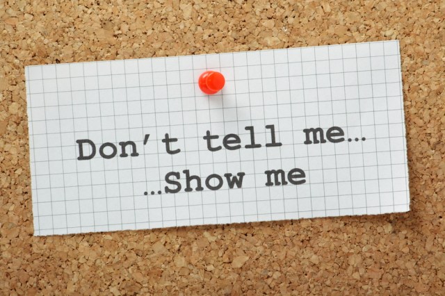 Image: Paper pinned to a corkboard stating Don't tell me, show me