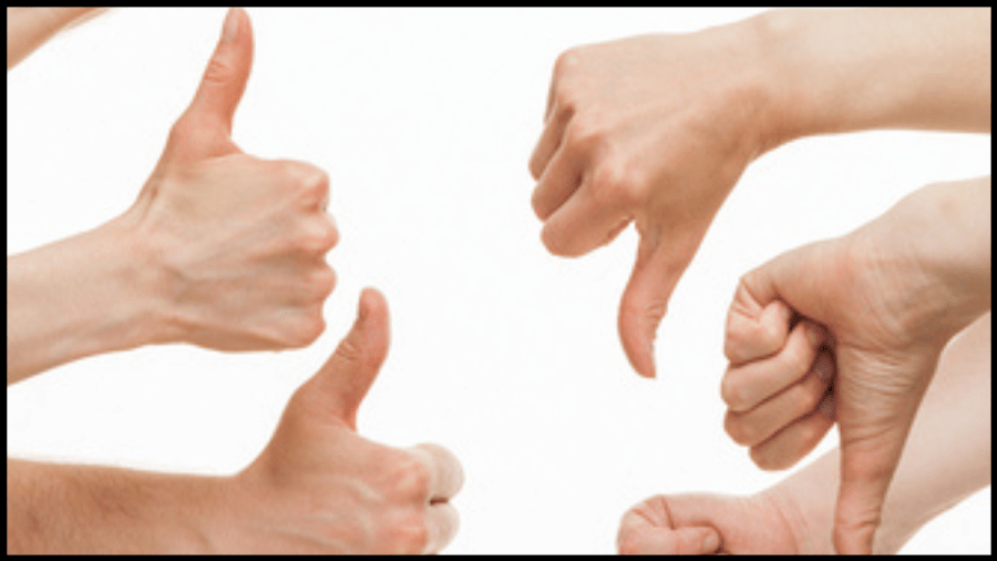 Photo of hands, some with thumbs up and some with thumbs down