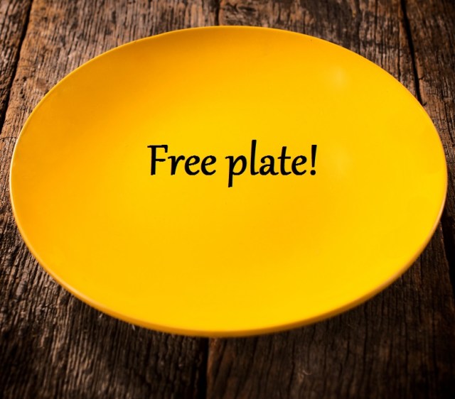 Empty yellow plate on the wooden background. Text across the plate reads "Free Plate!"