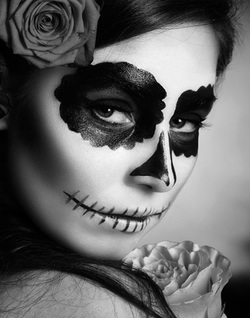 Headshot of writer Stephany Irwin, with her face painted in the look of a skull and with a rose in her hair.