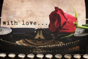 red rose on typewriter