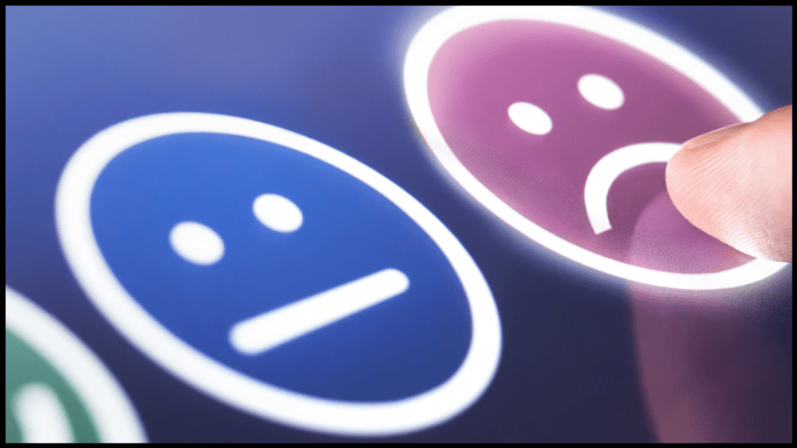 Image of a happy face, neutral face and sad face icons and a finger tapping the sad face.