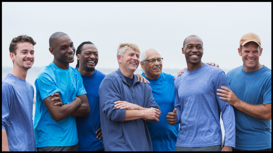 Photo of several men of different races and ages. All wearing blue tops