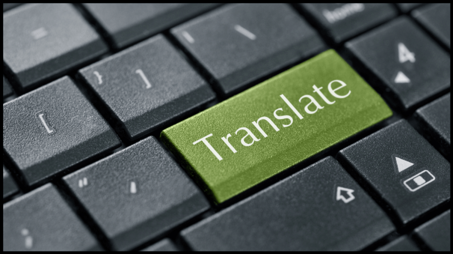 Close up photo of a laptop keyboard with one key being green with the word Translate in white written across.