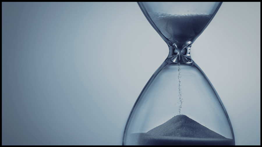 Photo of an hourglass with the sand running through