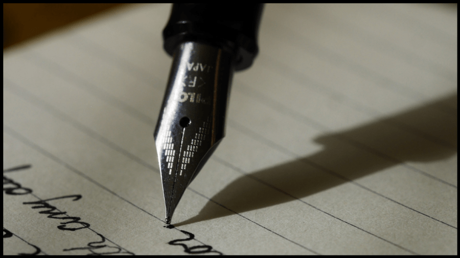 Close up photo of a fountain pen nib writing on paper.