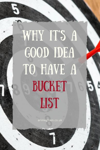banner Why it's a good idea to have a bucket list - image of a dart board with a dart in the bullseye