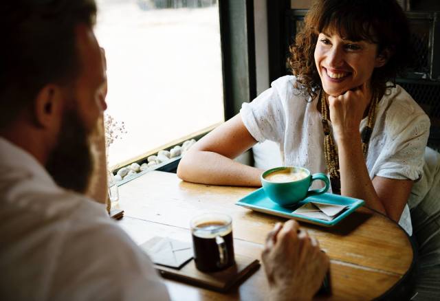 Comunication. Two people enjoying a coffee together