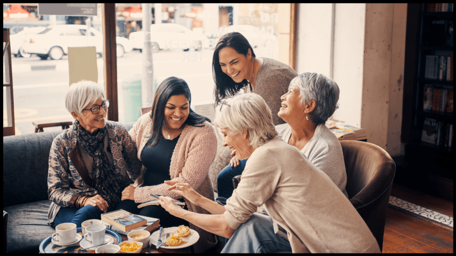 Group of women sitting around chatting and laughing