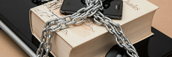 Image: Protect your work. Laptop, book and phone padlocked