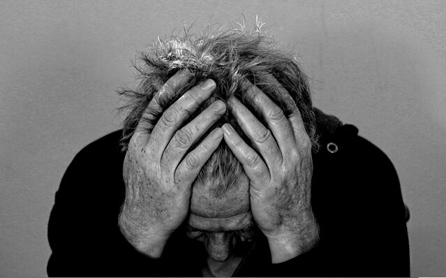 Featured Images - man holding his head in his hands