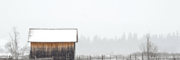 Image: Simple wooden house in snowy field