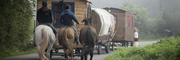 Image: Wooden gypsy caravans and horse riders