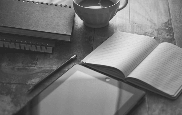 Featured Images - Notepard, table, cup and pen on a desk