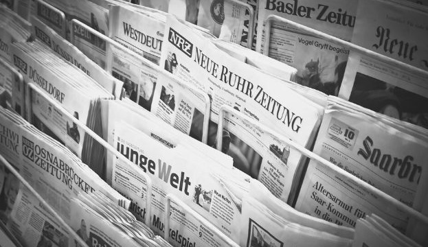 Featured Image - racks of newspapers - image from Pixabay