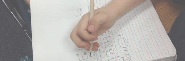 Child writing in a notepad