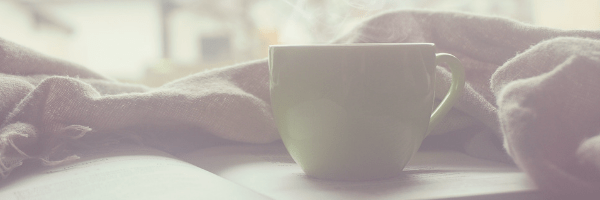 Coffee cup resting on a book, warm blanket.  Relax, read, chill.  Image from pixabay