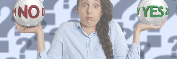 Making decisions, analysis paralysis. Woman holding a Yes and a No. Image from Pixabay