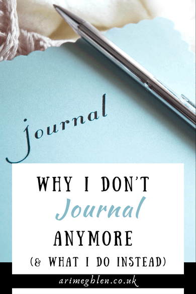 Close up photo of a pale blue journal with the word "journal" on the front. A pen rest on the cover. Text overlay reads: Why I Don't Journal Anymore (and what I do instead) AriMeghlen.co.uk