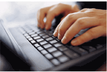 Hands typing on a keyboard