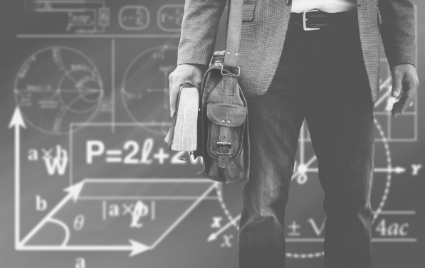 Featured image of a man with a book and satchel, standing before a chalk board full of equations.