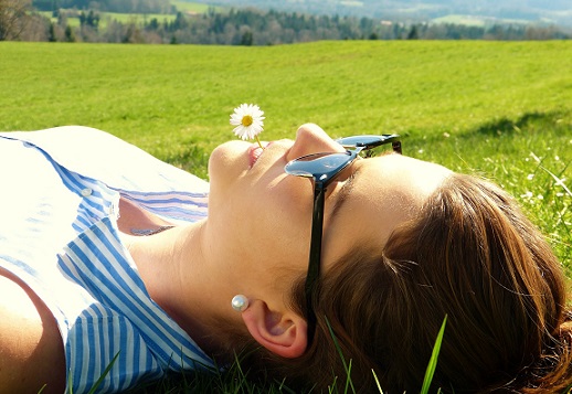 Woman lying in a meadow, relaxing.  Picture from Pixabay