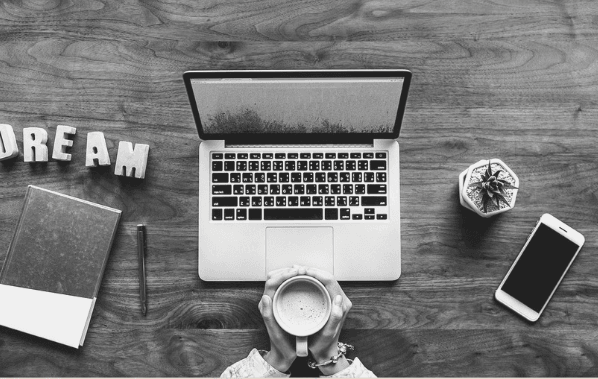 Featured Images - Laptop on a desk, person holding a mug and the word DREAM on the desk. Image from Pixabay