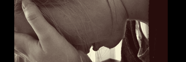 Image of a woman with her head in her hands.  Image from Pixabay