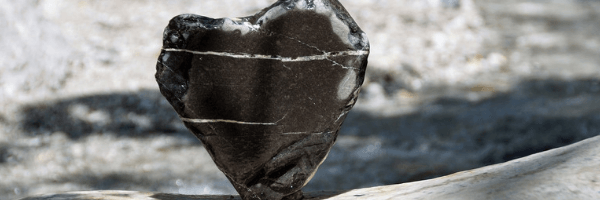 Image of a jagged black stone in the shape of a heart.  Image from Pixabay
