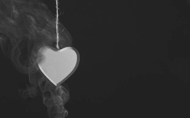 Featured Image - Wooden heart suspended on rope before a black background, surrounded by smoke. Image from Pixabay