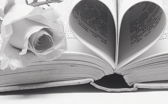 Featured Image - Image of a book with pages curled into a heart shape and a rose beside. Image from Pixabay