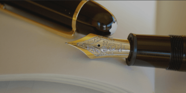 Blog Image - Fountain pen resting on an open notepad. Writing.