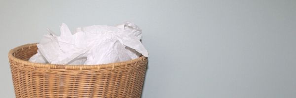 Photo of top of waste paper basket, full of discarded papers. Image from Pixabay