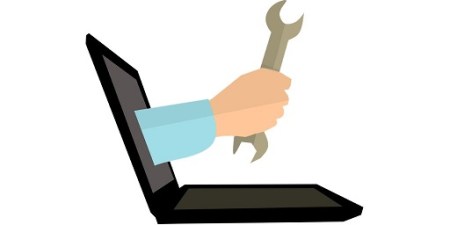 Blog Image - Vector image of an open laptop with an arm coming through the screen holding a spanner. Image from Pixabay