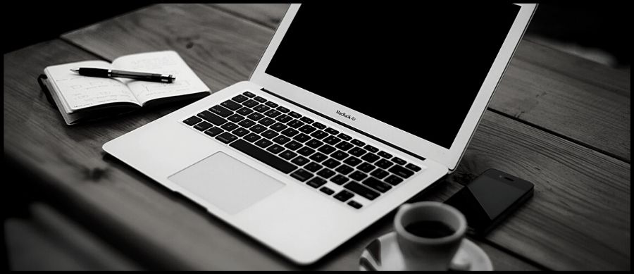 Blogger Series. Image of a laptop, pad and a coffee