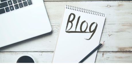 Flat lay desk image with laptop and a pad with the word "blog" written on it. Image from Canva