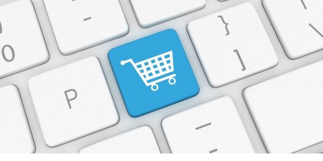 White keyboard image with a blue key with a shopping cart image on it. Image from Canva