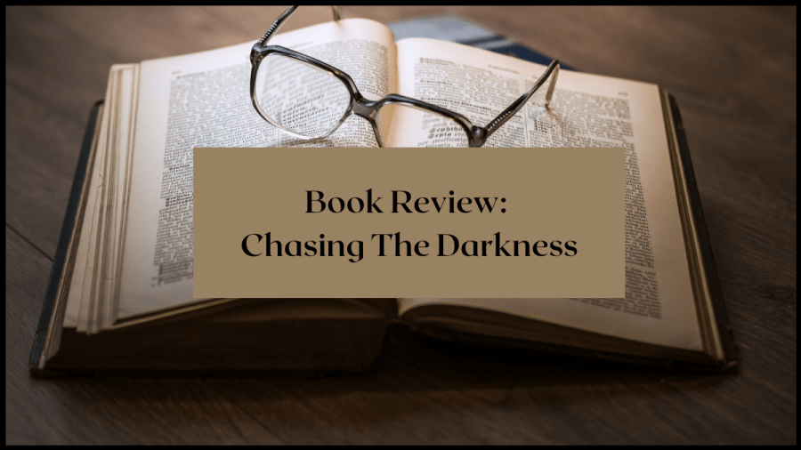 Book Review: Chasing the Darkness. Image of an open book with glassing resting on top