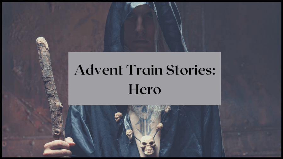 Image of a man in a black hooded cloak with a staff. Text reads Advent Train Stories: Hero