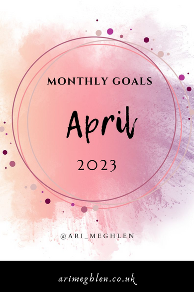 A pink and purple splatter of watercolour with circles and the words inside the circles are Monthly Goals April 2023. Arimeghlen.co.uk