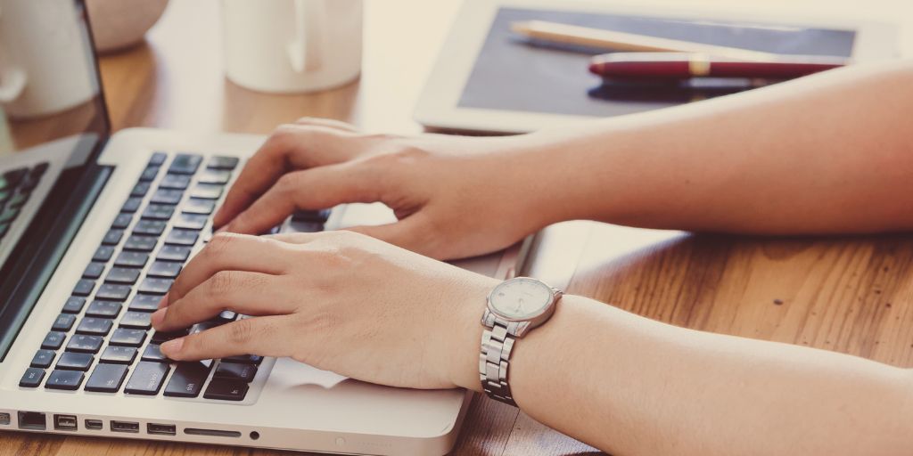 Image of hands on a laptop keyboard, typing
