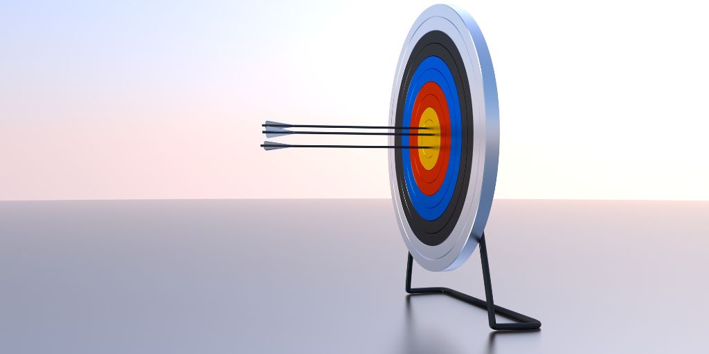 Photo of a archery target with three arros hitting the centre circle