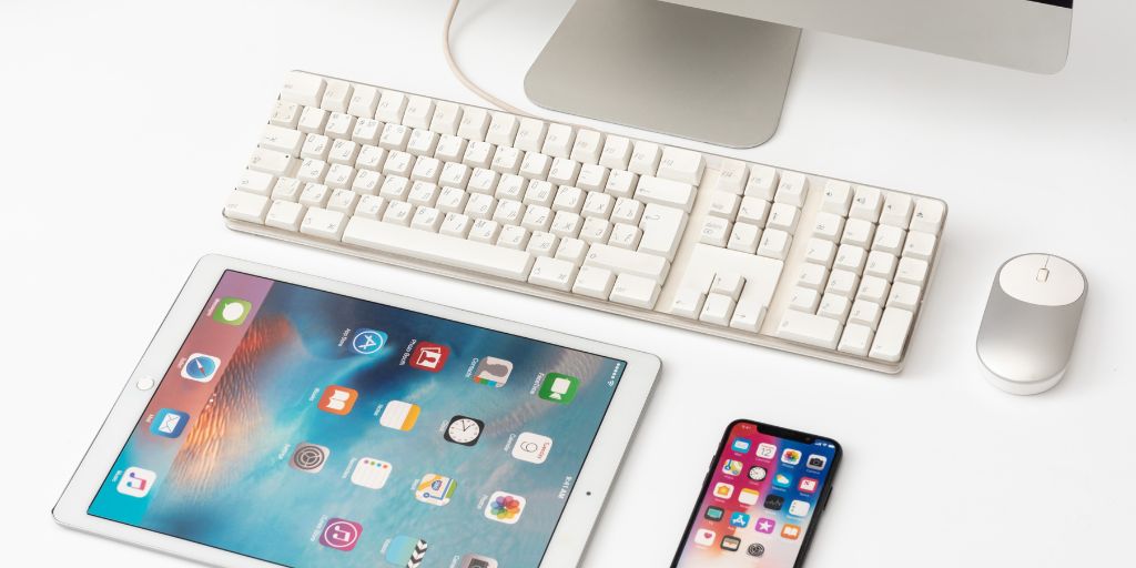 Photo of a computer keyboard, tablet and phone. Image from Canva Pro