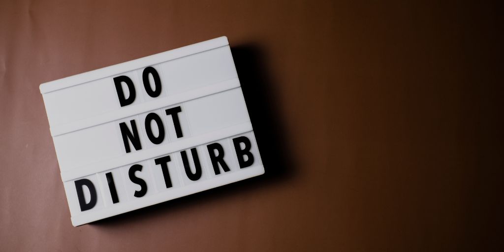 Photo of a sign that reads Do Not Disturb. Image from Canva