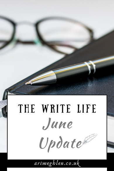 Image of a black leather notebook with a pen resting on top and glasses in the background. Text overlay reads The Write Life June Update. AriMeghlen.co.uk