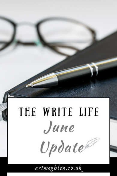 Image of a black leather notebook with a pen resting on top and glasses in the background. Text overlay reads The Write Life June Update. AriMeghlen.co.uk