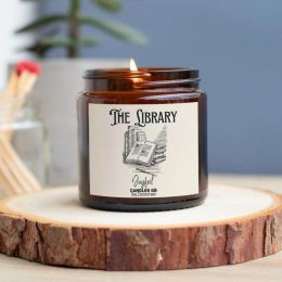 Candle in glass jar with the name The Library