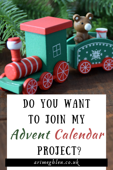 Photo of a green and red wooden Christmas Train with the text overlay reading: Do You Want To Join My Advent Calendar Project? AriMeghlen.co.uk